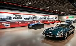evolution automotive timeline, informative, illustrating significant car models across decades, photorealistic, museum-style exhibit with interactive digital kiosks, highly detailed, seamless progression display, neutral colors with spotlight focus, overhead LED lighting, shot with a tilt-shift lens
